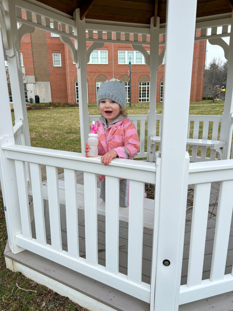 Teaching Children to be Flexible-Minded. Young girl smiling in gazebo outside.