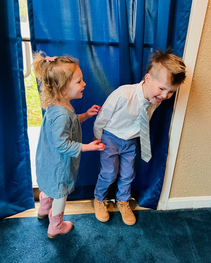 A brother and sister all dressed up for church laughing together building strong sibling relationships.