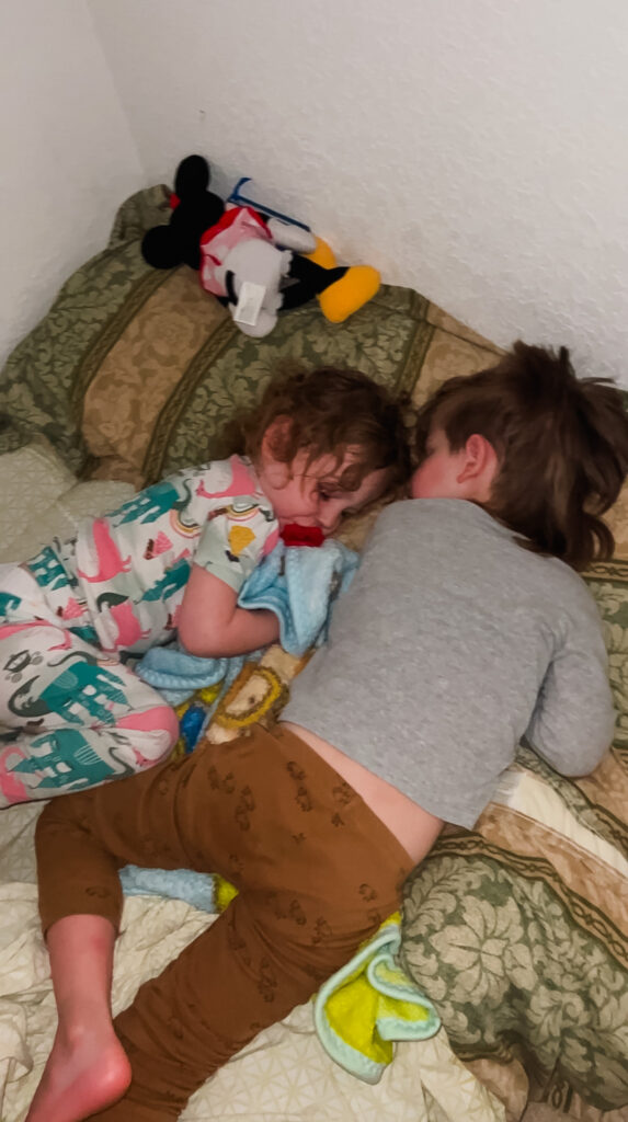 Strong Sibling Relationships: A brother and sister having a sleepover on vacation on an air mattress in a walk-in closet.