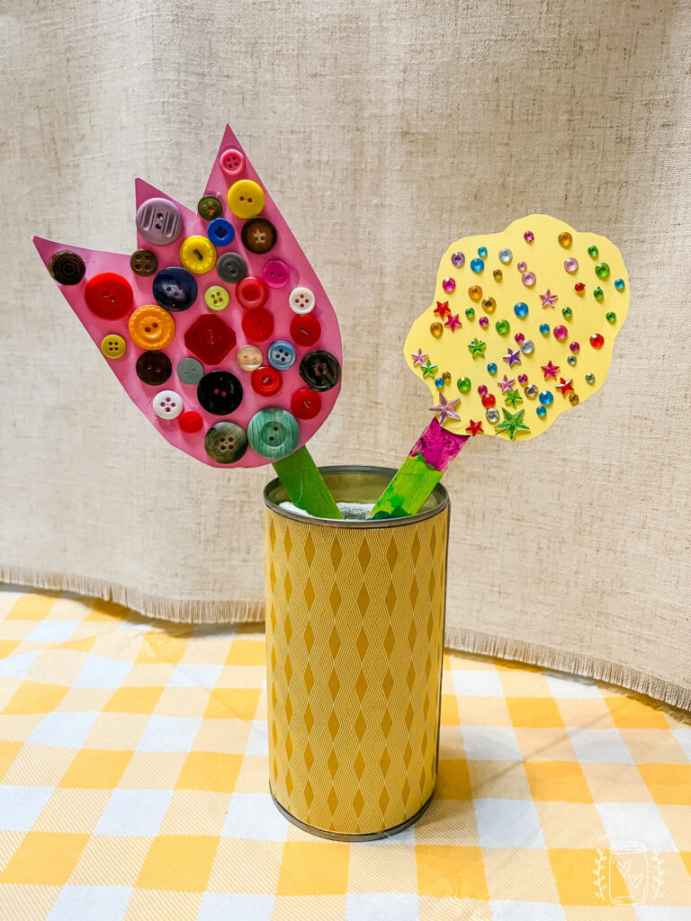 Spring flower craft made with buttons and stickers.