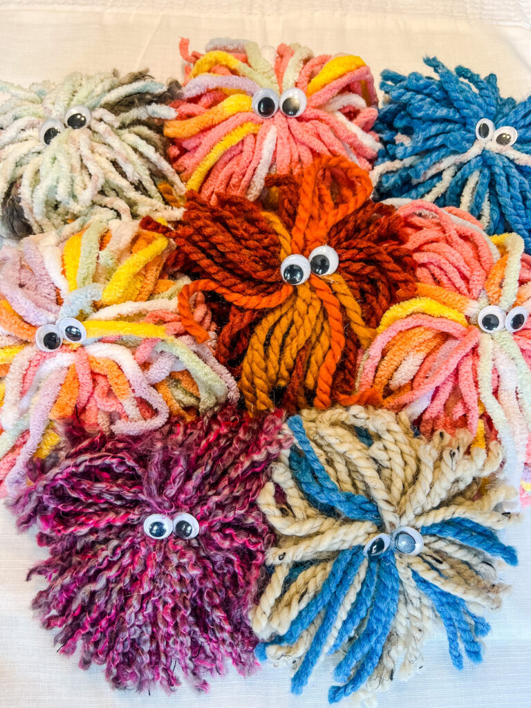Fuzzy Monsters made out of yarn and googly eyes.