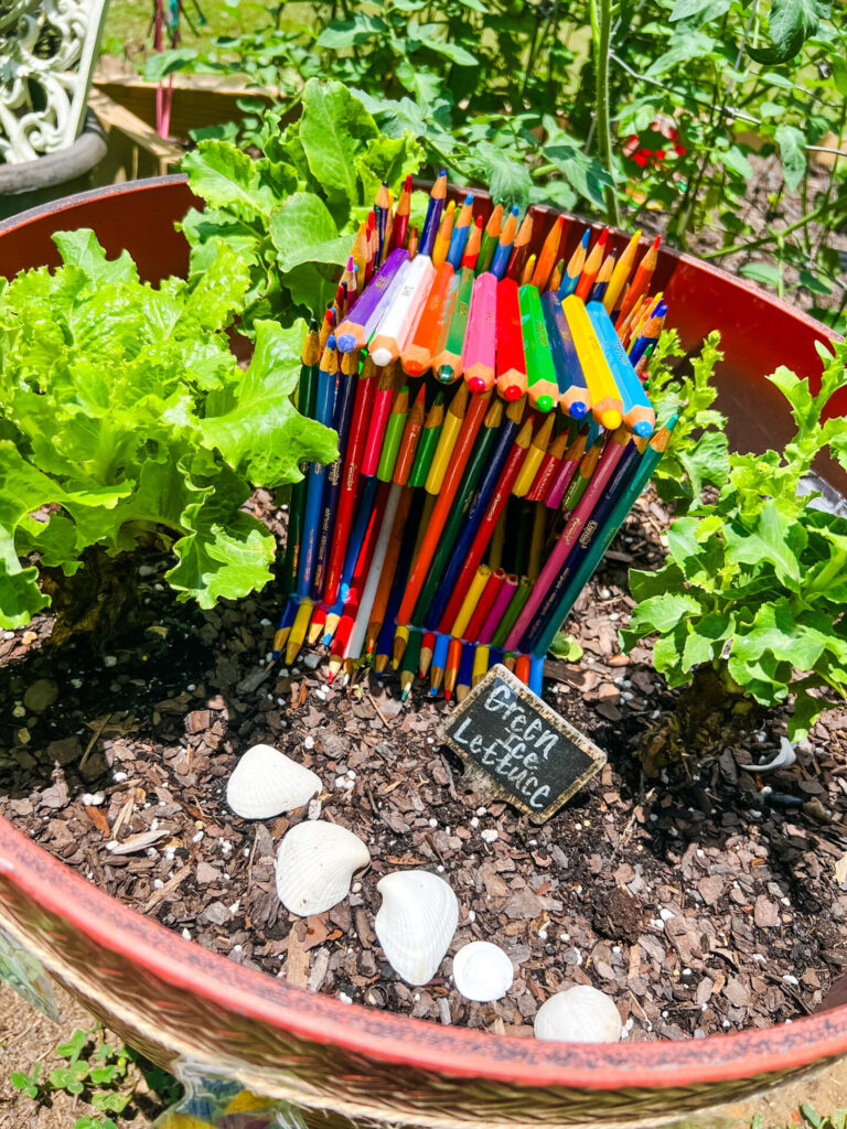 Garden fairy house made out of colored pencils.