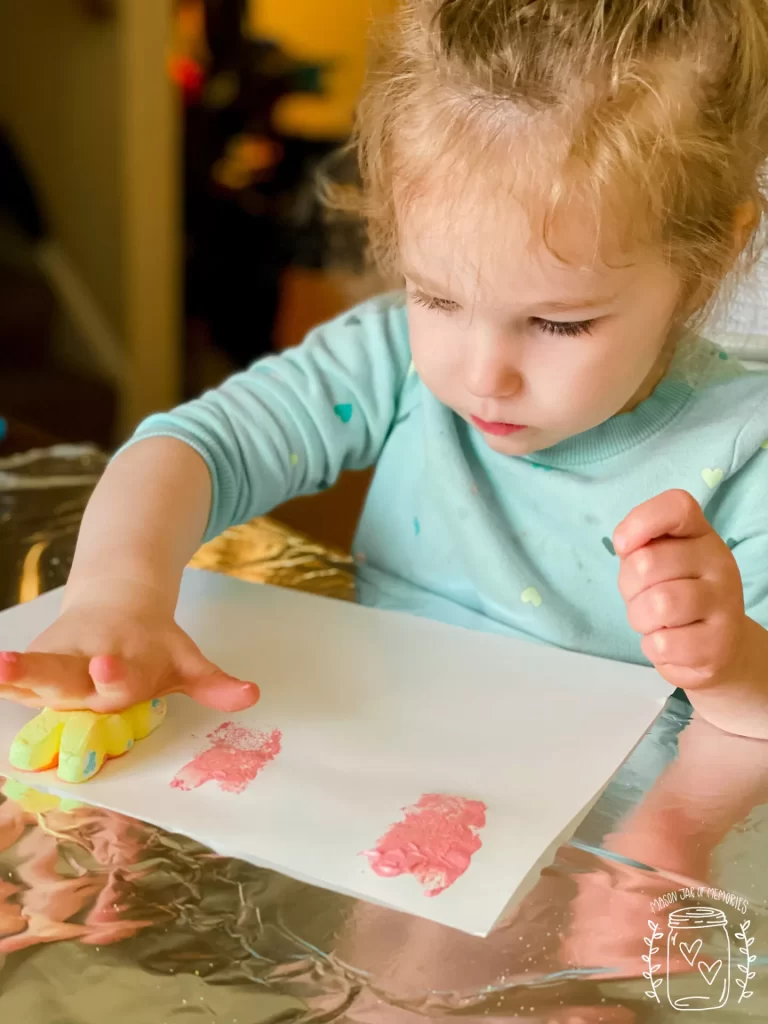 Preschool girl doing a stamping activity