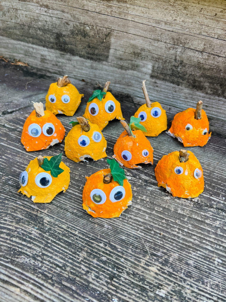 Egg Carton Pumpkins for Kids using egg cartons, orange paint, googly eyes and outdoor sticks. A fantastic DIY Fall Craft for Kids.