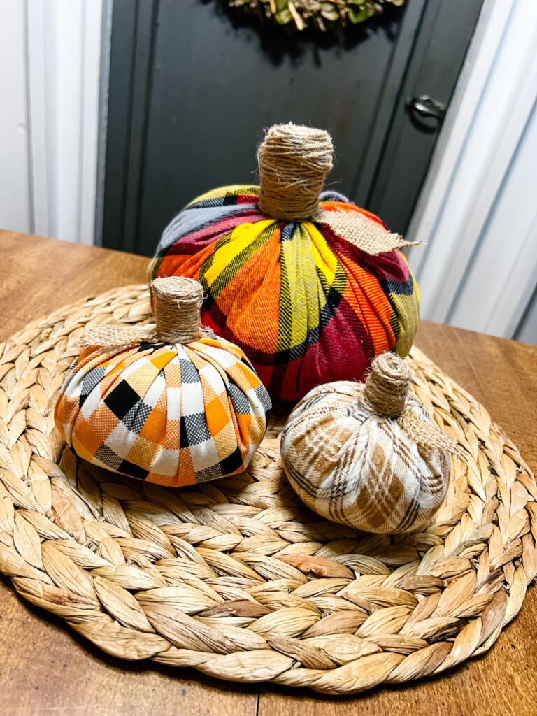 Fabric Pumpkins, DIY Fall craft with three fabric pumpkins made with fabric, stuffing, twine, and burlap.