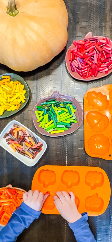 Fall-Themed Crayons Set Up with crayons sorted in pumpkin dishes by the colors, red, yellow, green, brown, and orange.