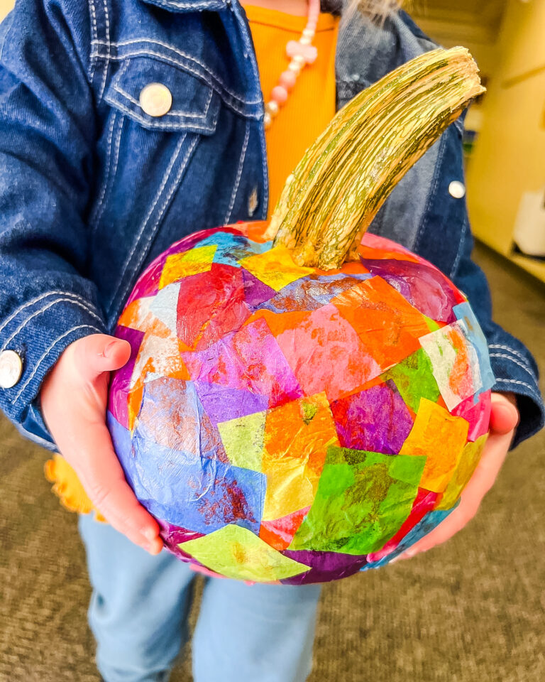 Pumpkin Craft decorated with Mod Podge and colorful squares cut from tissue paper.