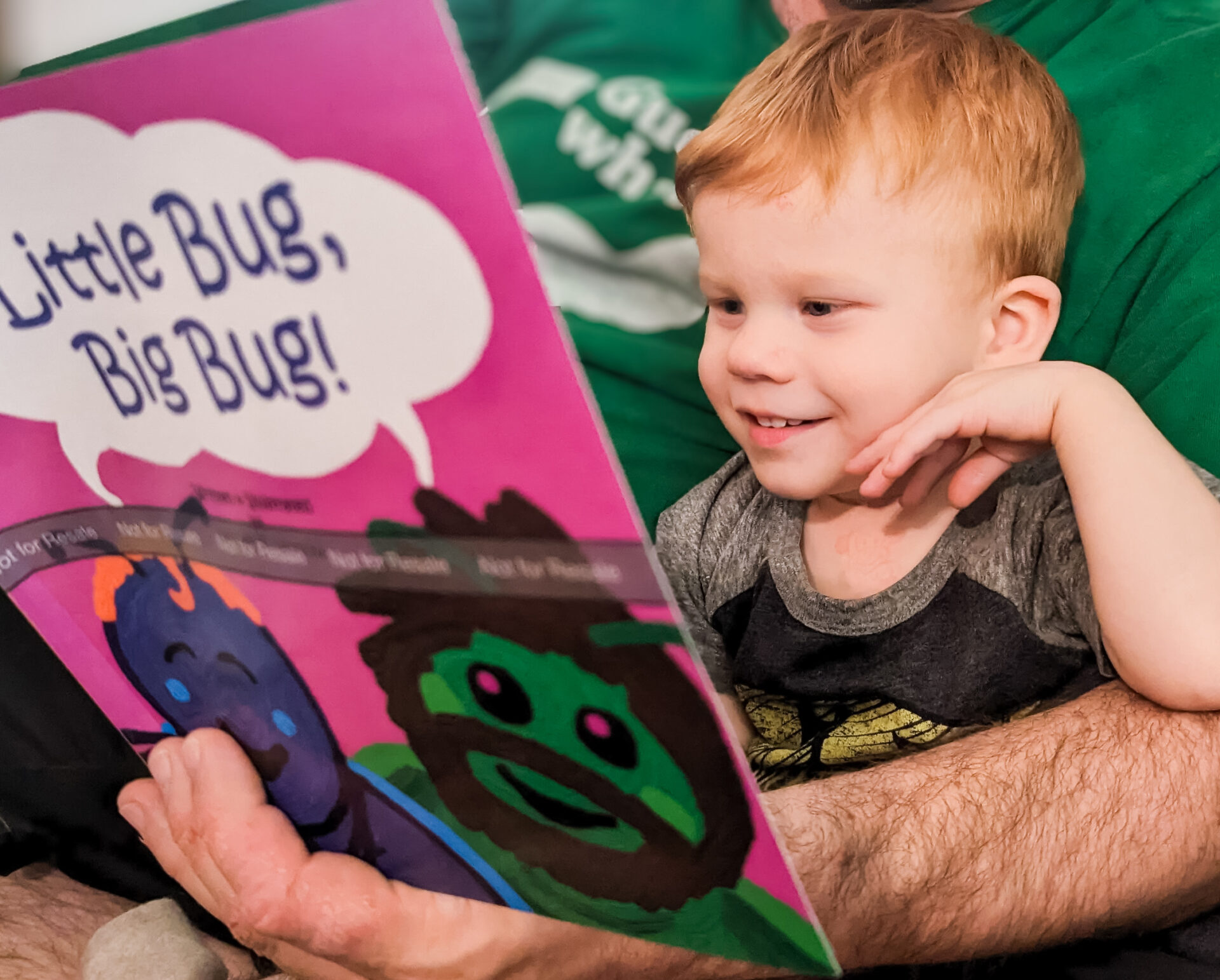 Boy reading book with father